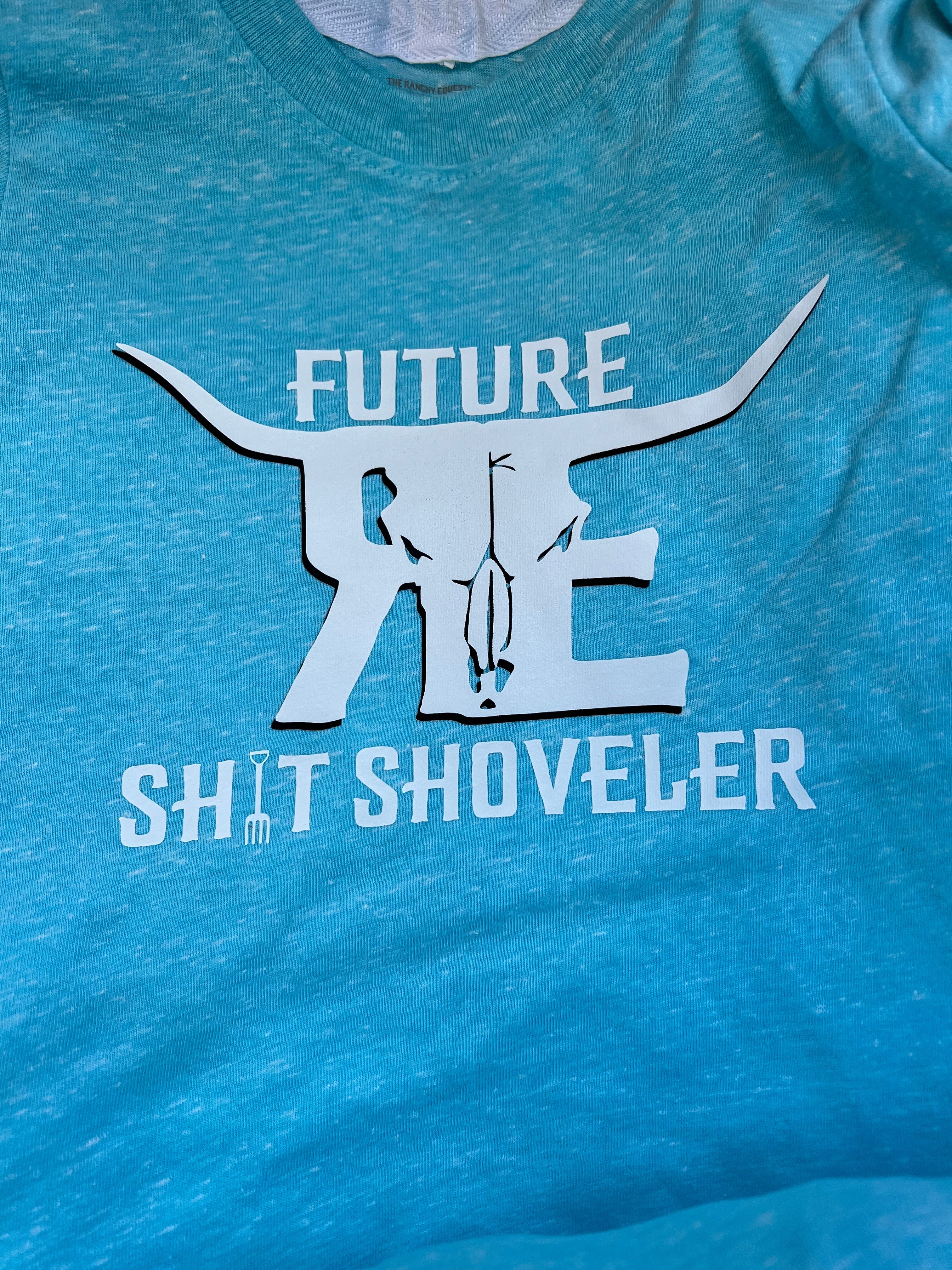 future sh!t shoveler with ranchy bullhorns logo in white on a teal blue tee shirt for toddlers